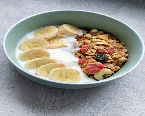 Healthy breakfast bowl with fruits yogurt and nuts