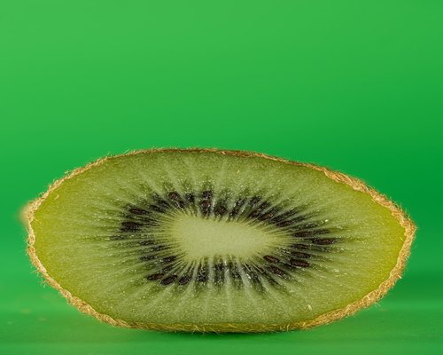 Sliced Kiwi fruit showing green texture and seeds